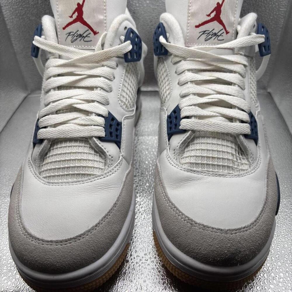 White and blue Jordan 4 trainers
